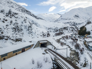 Aerial view of tunnel entrance of railroad. Train tracks of Furka tunnel in Realp, Switzerland.