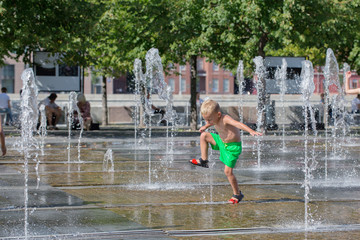 Children enjoy the city fountain