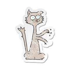 retro distressed sticker of a cartoon cat scratching