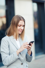 Young woman wearing casual using smartphone outdoor