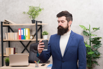 Reasons coffee improves office culture. Man bearded manager businessman entrepreneur hold cup of...