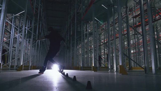 Slalom on a roller in a logistics center in backlight