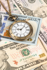 Vintage pocket watch clock on dollar banknote concept for money time value