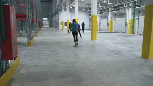 Many people on the rollers and trick in the logistics center
