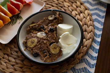 baked oatmeal with banana, blueberries, walnut and raisins.  served with yoghurt