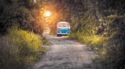 hippie bus on the road in sunset
