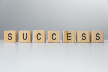 Success word from wooden blocks on desk. Business success