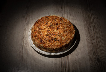 Homemade apple pie dessert on a wooden table closeup.