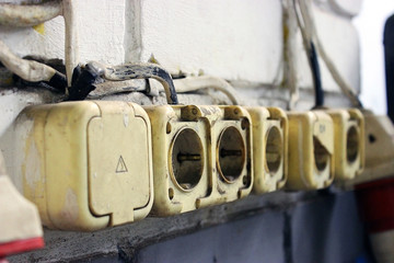 Old dirty sockets on a brick wall