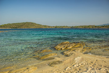vivid tropic sea lagoon with bright colorful blue and green calm water surface near stone rocky...