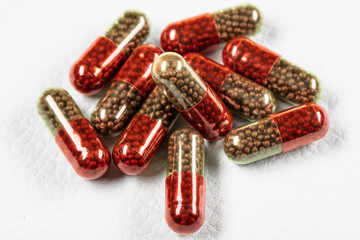 medical capsule with granules (pill) on a white background.