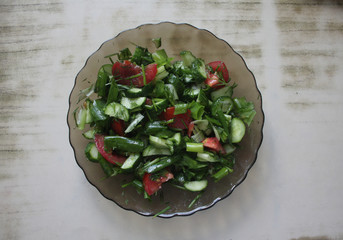 Dish consisting of cucumber salad with green onions and tomatoes.