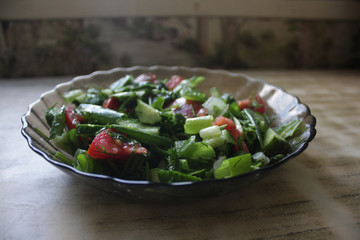 Dish consisting of cucumber salad with green onions and tomatoes.