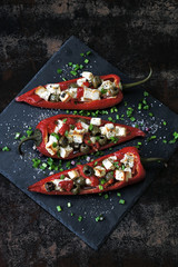 Baked red paprika stuffed with feta and olives. Keto diet. Keto recipe. Vegetarian lunch idea.