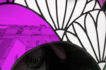 Colorful Stained-Glass Window. Abstract Multicolored Background. City Behind Glass