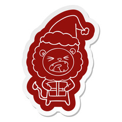 cartoon  sticker of a lion with christmas present wearing santa hat