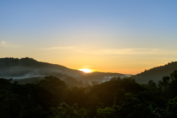 Tropical forest mountain with fog and mist in morning during sun rise at Hang Dong district in Chiang Mai, Thailand