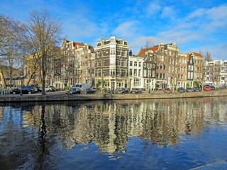 Fototapeta na wymiar Reflection of Amsterdam in city canal