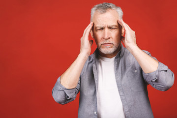 Portrait of a groggy upset worried sad, depressed, tired senior man with a headache, very stressed,...