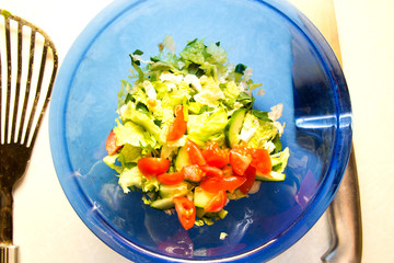Diet. Healthy food. A fresh vegetable salad. Vegetarians. View from above. Blue plate.