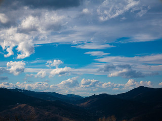 Beautiful landscape in the mountains at sunset. View of colorful sky with amazing clouds.