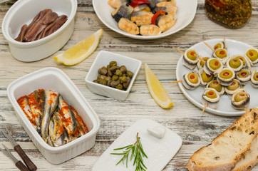 Marinated herring and anchovy fillets.   Fish tapas – antipasto. Rollmops (rolled marinated fish fillets) 
