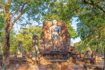 Fototapeta na wymiar Standing Buddha statue at Wat Phra Si Ariyabot temple in Kamphaeng Phet Historical Park, UNESCO World Heritage site