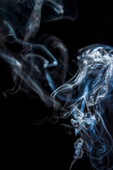 Fototapeta premium Close-up abstract beautiful smoke on a black isolated background. Blur and soft focus.