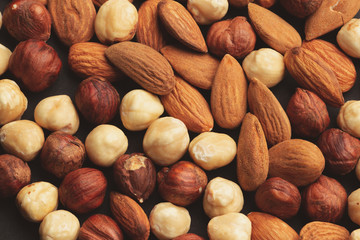 mix of different nuts on black table