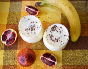 Milkshake with banana, red orange and flax seeds. Healthy lifestyle, diet.