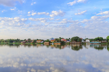 Fototapeta na wymiar Peaceful Kamphaeng Phet town waterfront on Ping River with reflection
