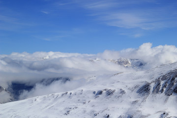 Fototapeta na wymiar Mountain peaks over clouds.