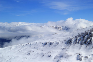 Mountain peaks over clouds.