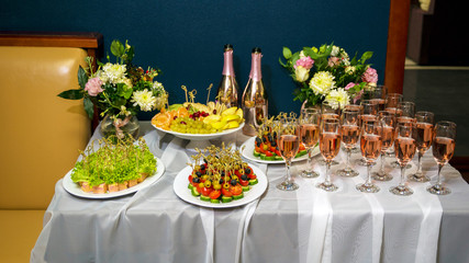 holiday table with champagne and snacks