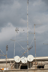 Satellite dishes of parabolic antennas on building roofs