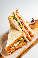 Sandwich with ham, cheese, tomatoes, lettuce, and toasted bread