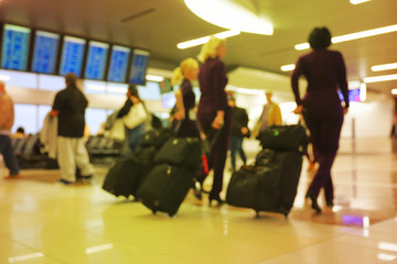 Defocus blurred bokeh of travelers in airport terminal traveling for work and vacation - abstract background