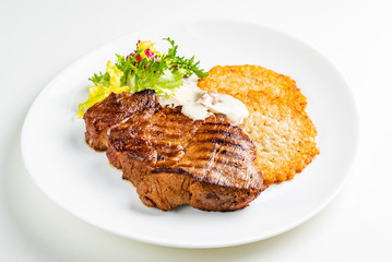 pork steak with potato pancakes and salad