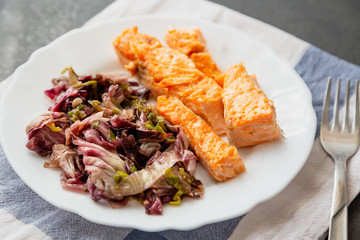 plate with salmon and red radicchio garnish