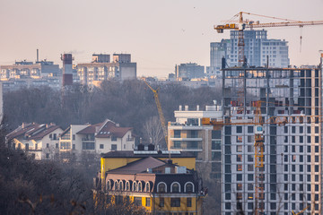 Early spring at sunny evening in warm weather. High rise residential areas around old historic center on the right bank of the Dnipro River. Ukraine Mar. 6, 2019