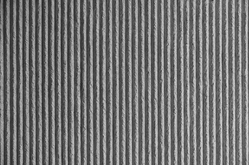 Surface of the wall with a decorative white plaster. Textured concrete wall with vertical lines and...
