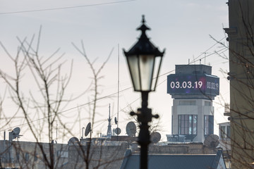 Early spring at sunny evening in warm weather. Refurbished electronic information display on the tower of the Trade Union House. Independence Square, Kyiv, Ukraine Mar. 6, 2019