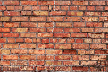 Old brick wall with scratches, cracks, dust, crevices, roughness. Can be used as a poster or background for design.