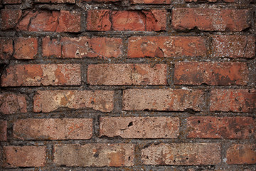 Old brick wall with scratches, cracks, dust, crevices, roughness. Can be used as a poster or background for design.