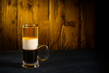 B52 alcohol cocktail shot on wooden background.