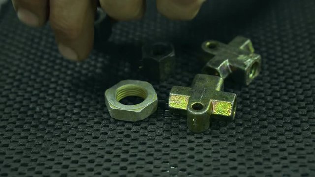 Men chooses nuts for car parts close-up