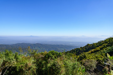 Fototapeta na wymiar Outdoor sunshine scenery range of mountain at Mon Chame, famous mountaintop in Chiang Mai, Thailand. Tranquility and retreat spot on the peak over tropical rain forest.