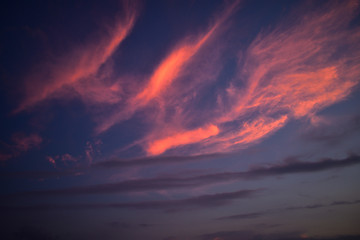 rays from sun after sunsets reflecting on clouds .