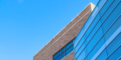 Blue sky over building with blue glass windows