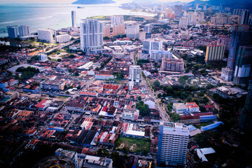 An aerial view of Penang state and Penang 1st Bridge with blue sky and ocean and big hills as background. Shot in komtar, Penang, Malaysia.